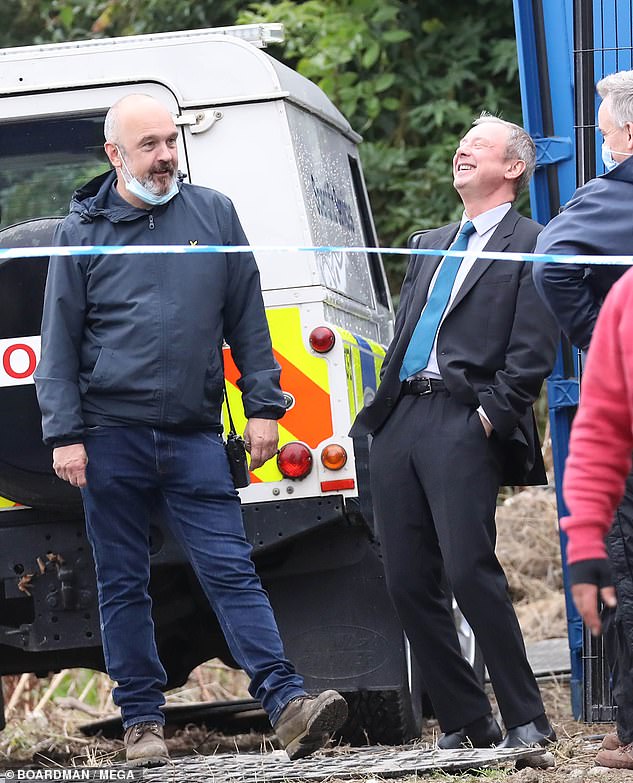 Born to entertain: John Simm looked in high spirits as he larked around filming season two of ITV police drama Grace in Brighton on Monday. Photo: Boardman/Mega